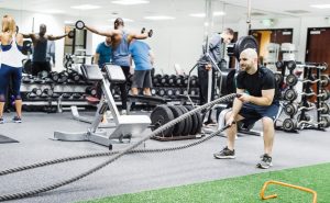 Fitness center photo with weights, machines, battle ropes, turf