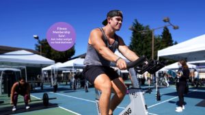 man on exercise bike in outdoor fitness center