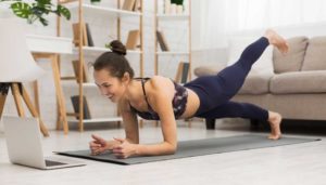 woman doing virtual yoga in living room