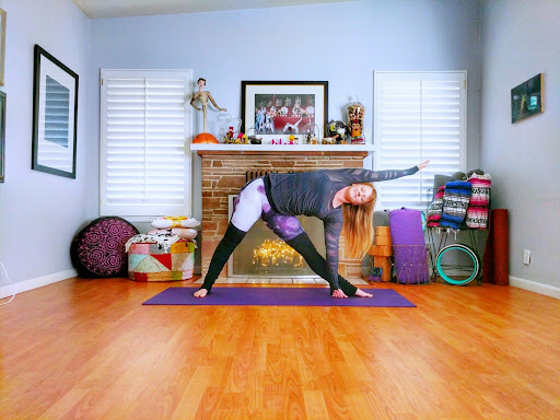 yoga triangle pose with instructor courtney